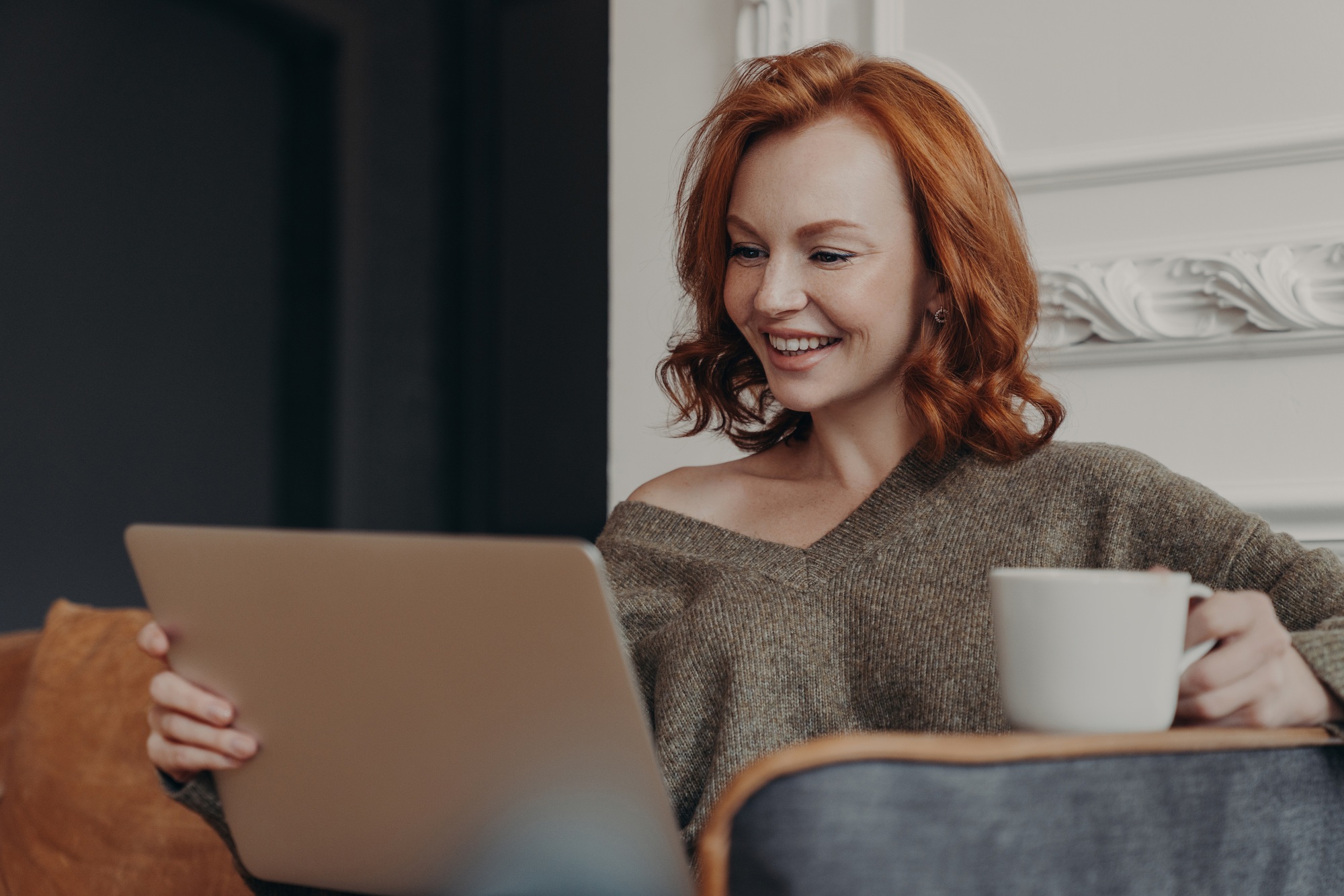 Beautiful positive redhead woman happy to have video call with best friend, share news with each oth