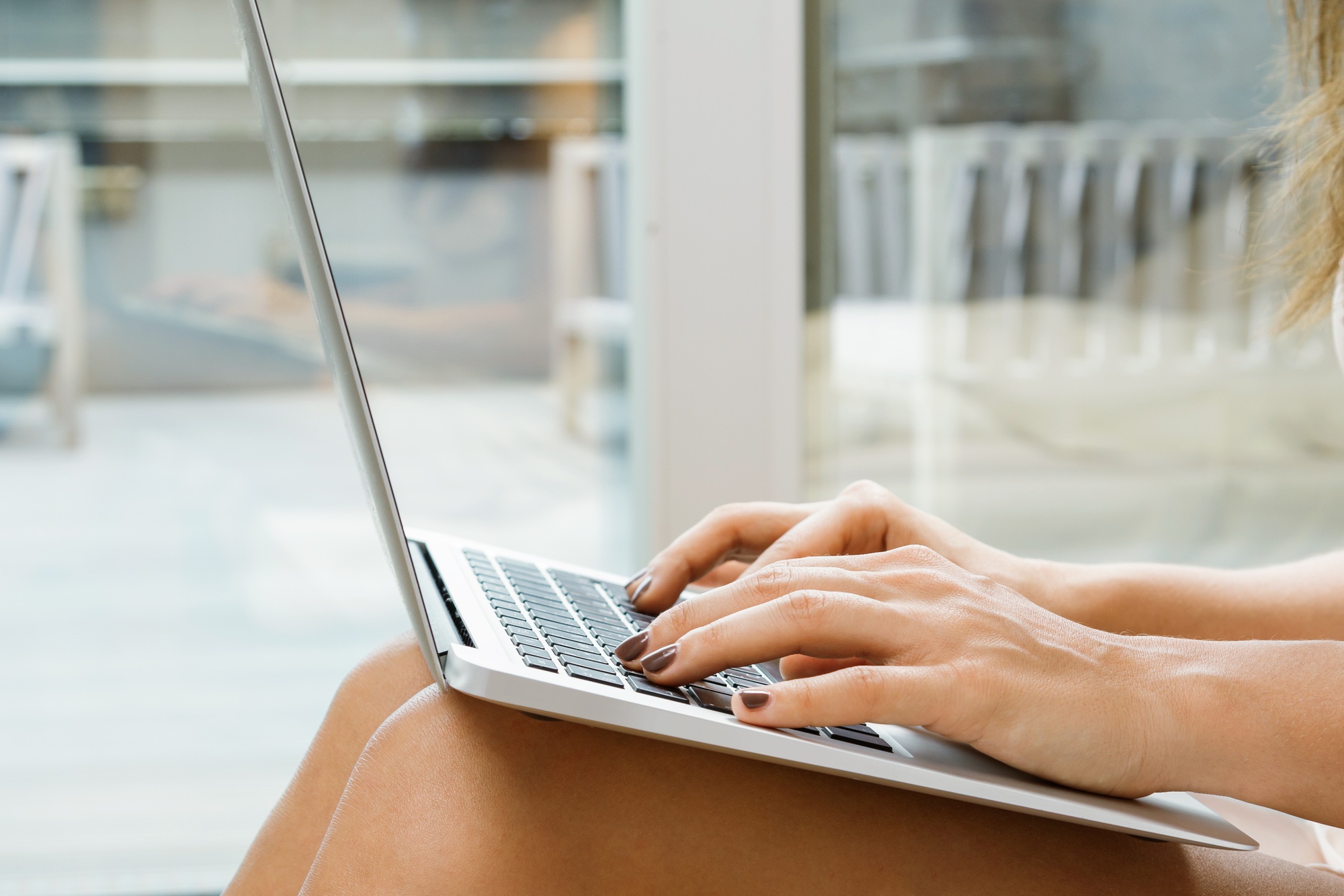 Woman using laptop pc. Female hands on the keyboard.